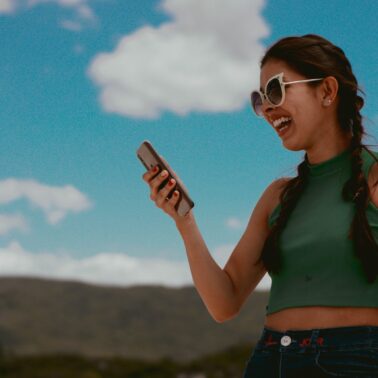 Woman holding phone and smiling