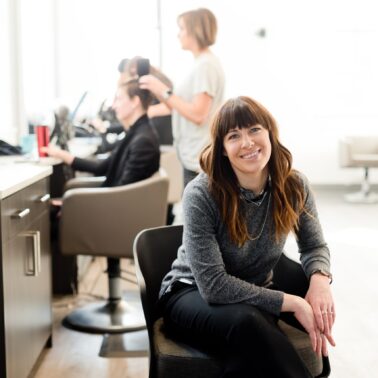 Self-employed hair dresser sitting in a chair