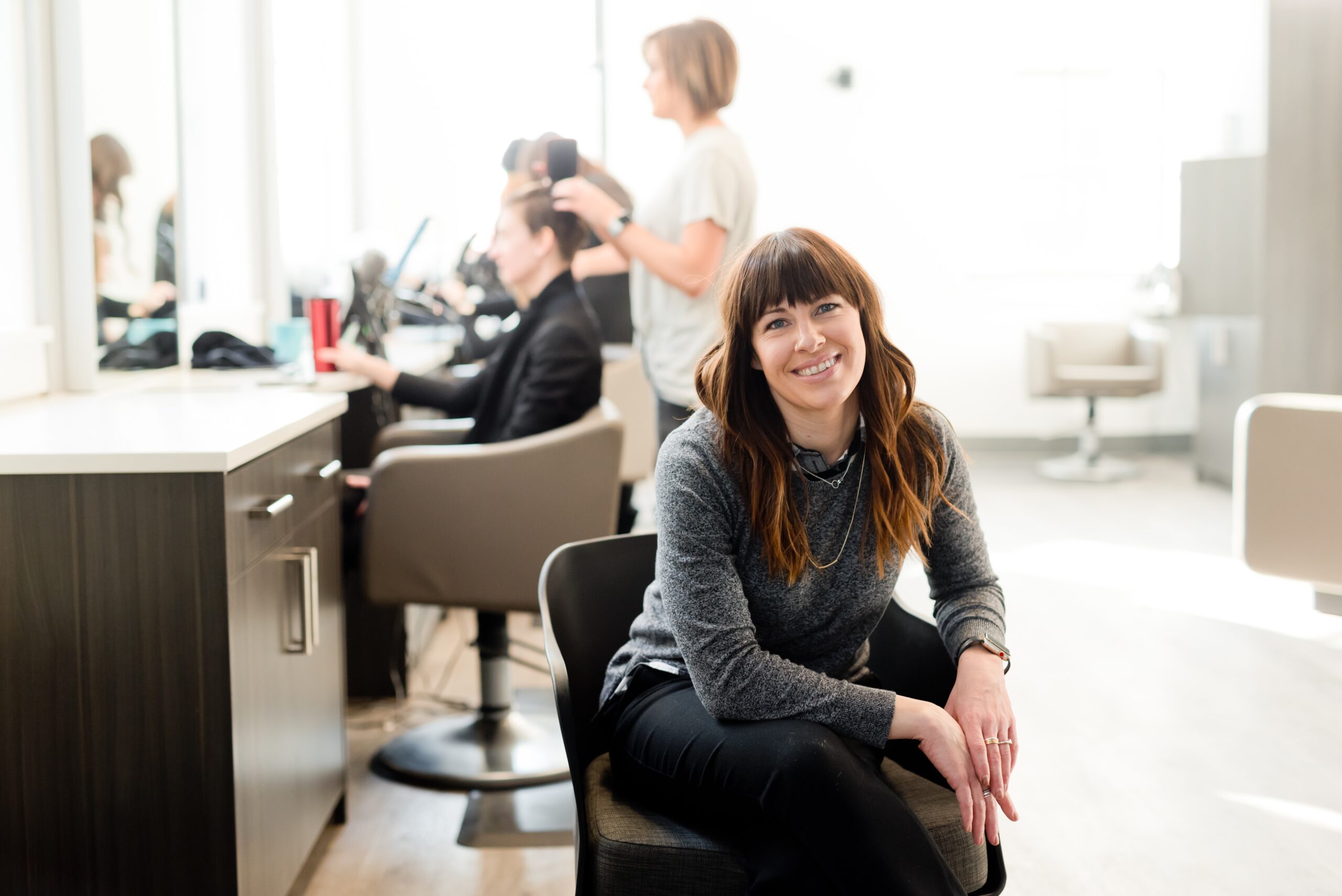 Self-employed hair dresser sitting in a chair
