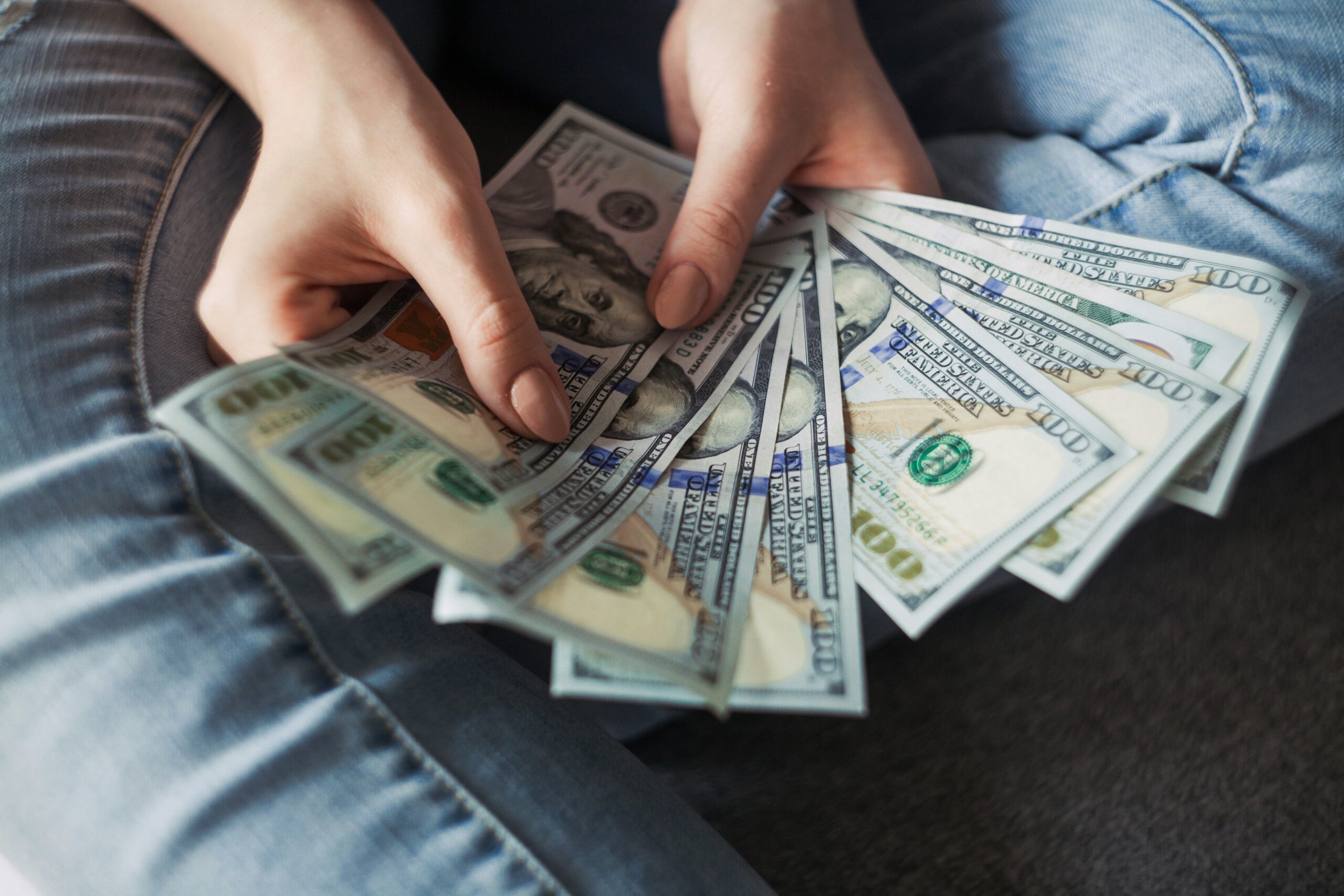 Person holding handful of cash