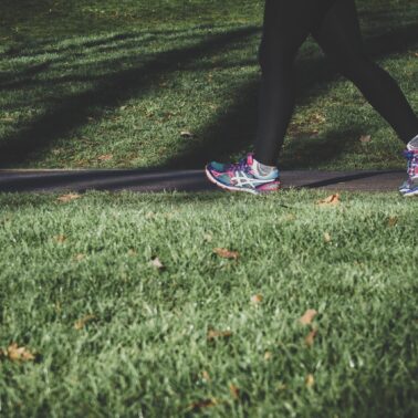 Person walking on trail wearing tennis shoes