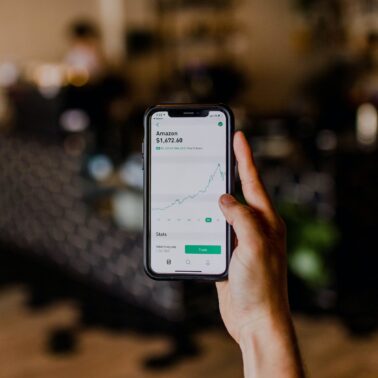 hand holding phone showing investment app