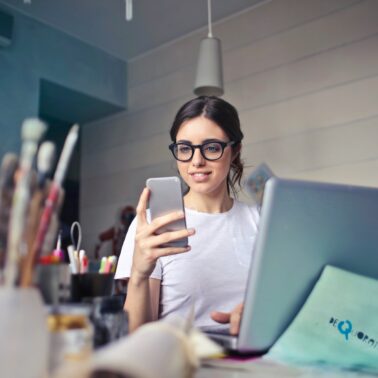 woman with phone and laptop