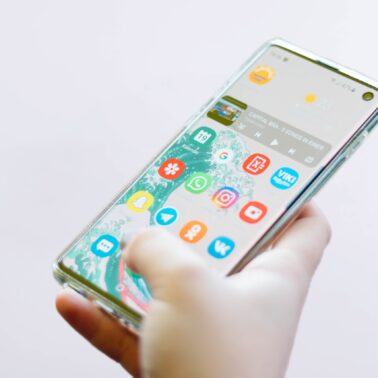 person holding smartphone with apps