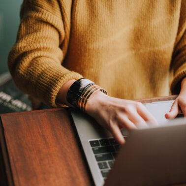 person taking online surveys on laptop