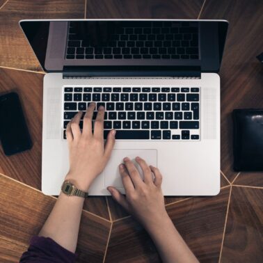 laptop open with person working online job
