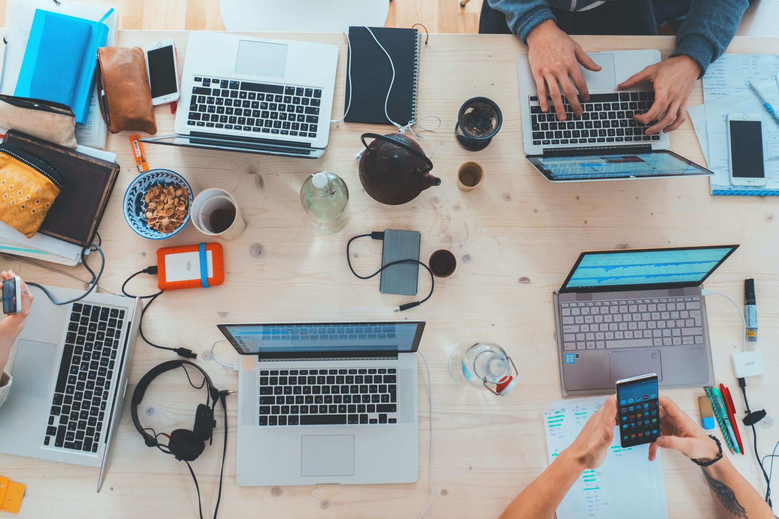 Over view of people working at a table on laptops