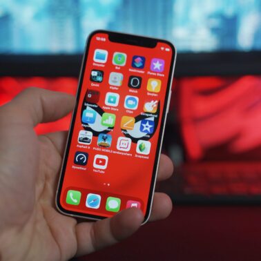 Person holding smartphone showing apps