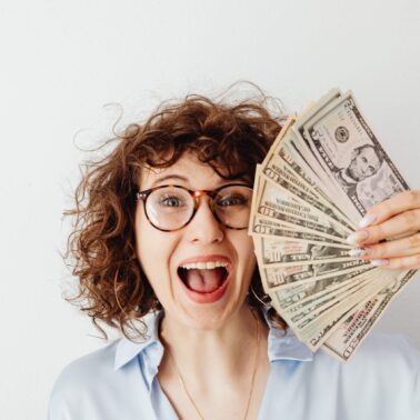 teacher holding extra money