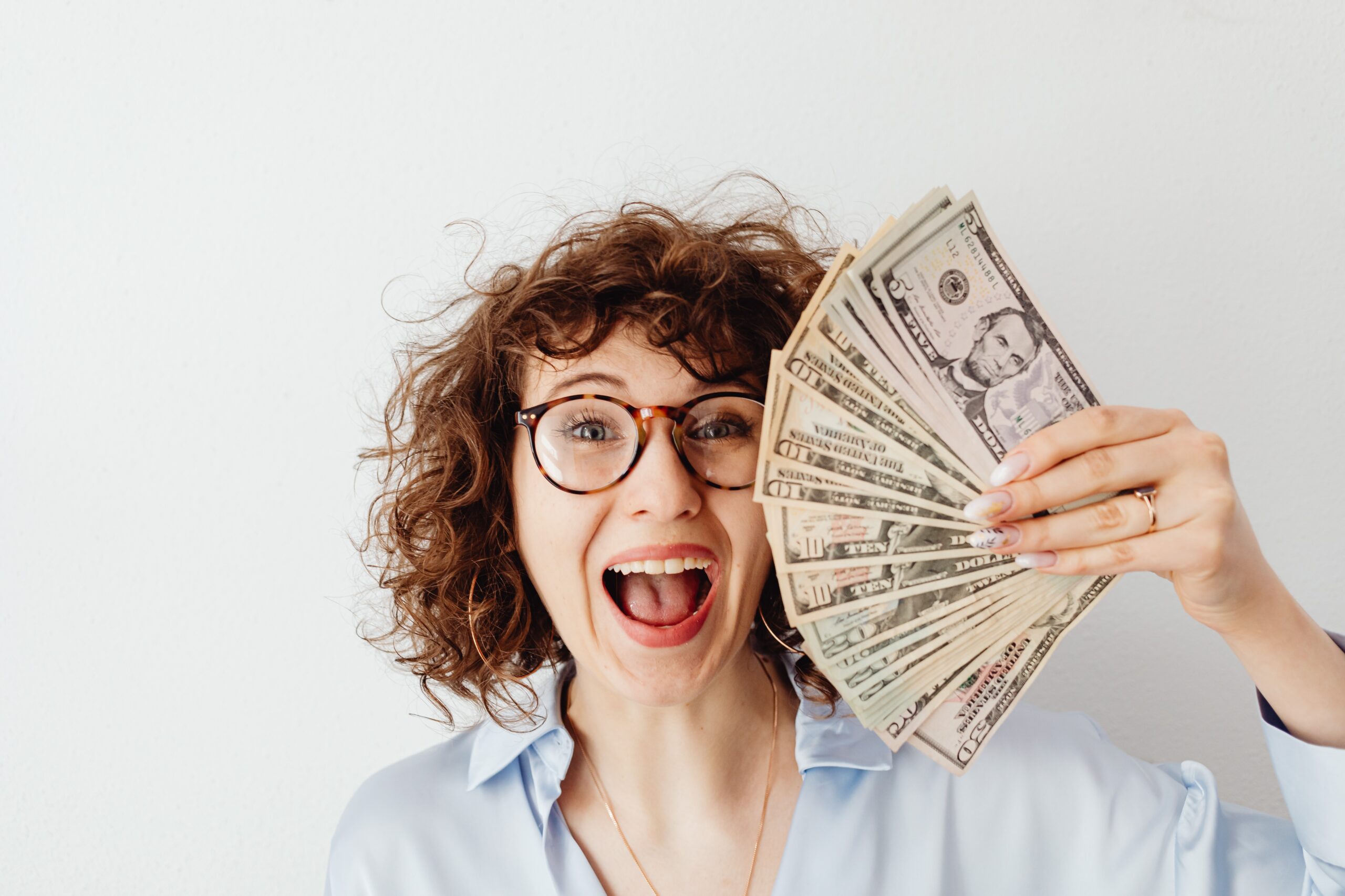 teacher holding extra money