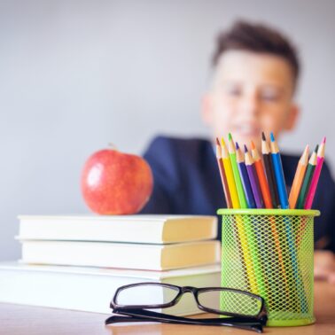 stack of books on a teacher's desk