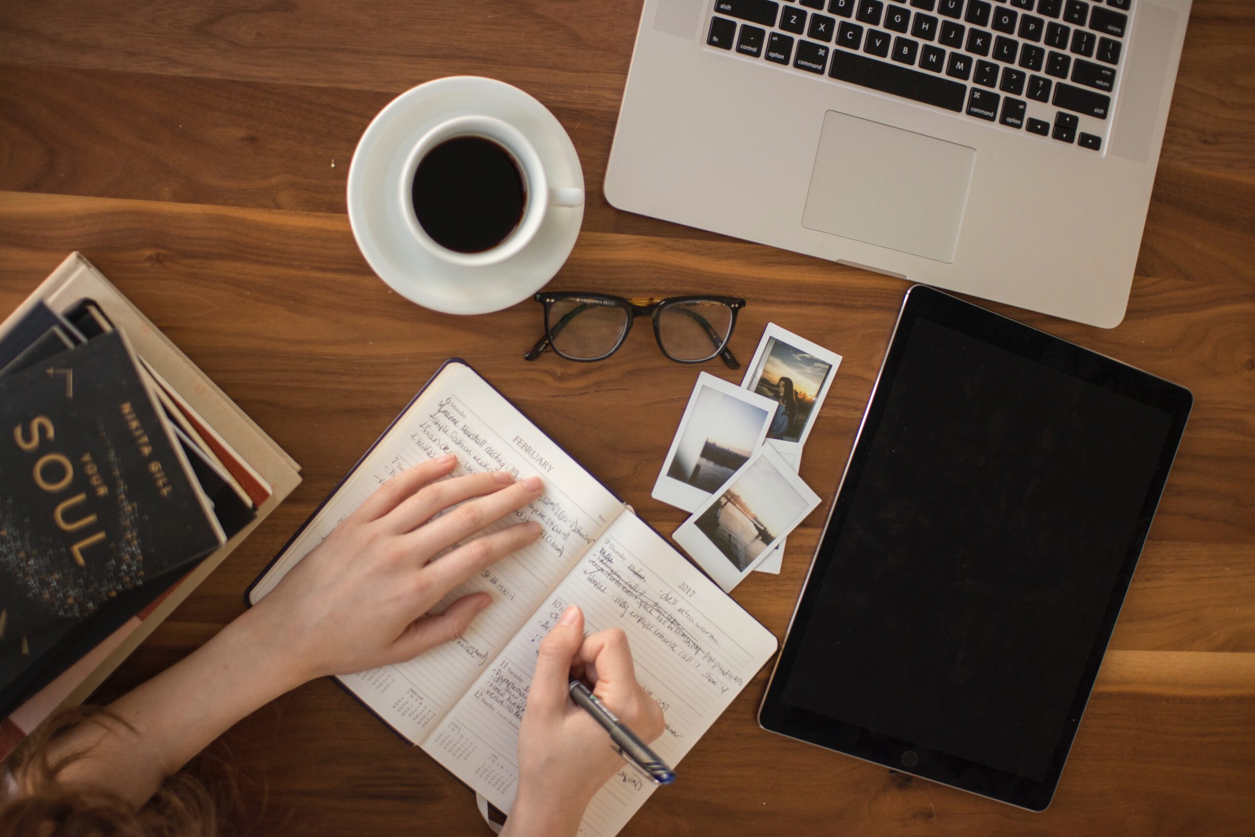 overview of person writing in notebook